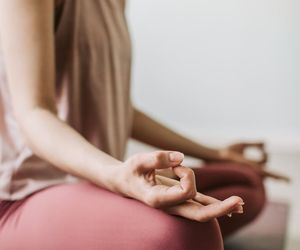 Close-up of hands in a meditative mudra position.